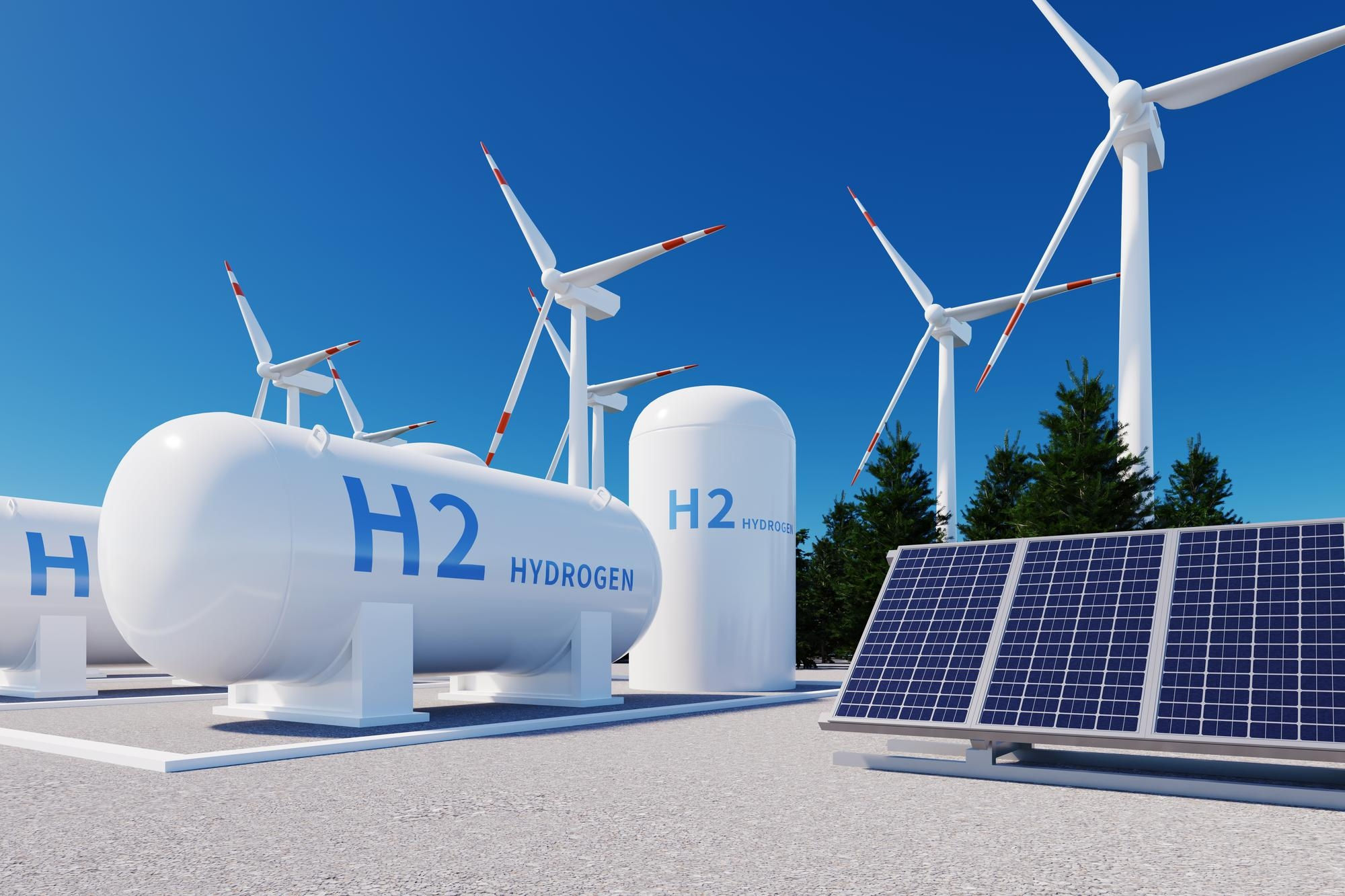 Paneles solares junto a un tanque de hidrogeno y unas turbinas de energía eólica